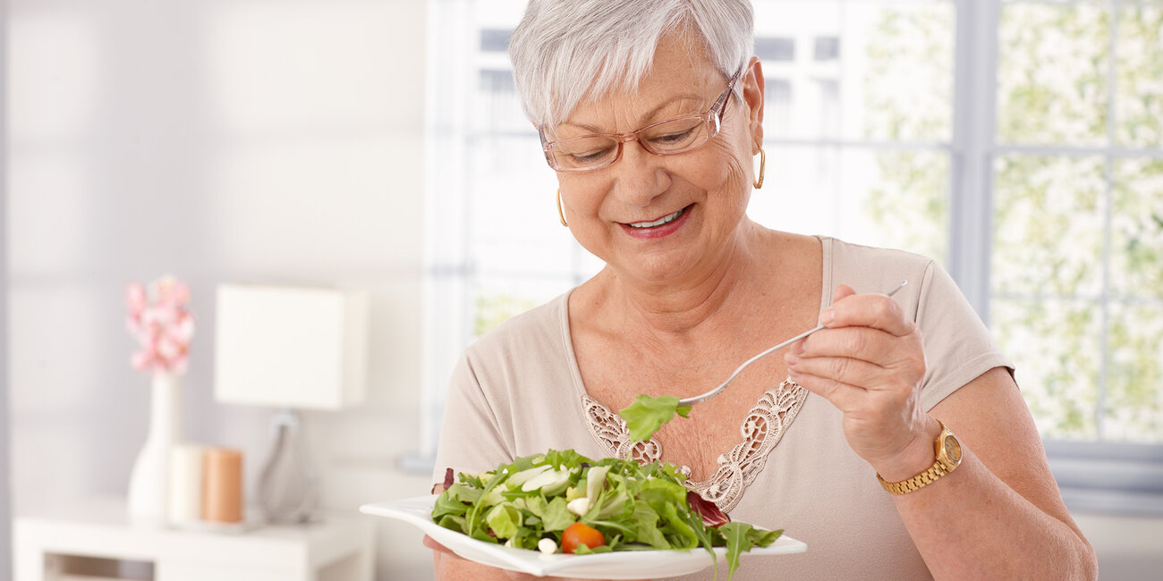 Ältere Frau ist Salat